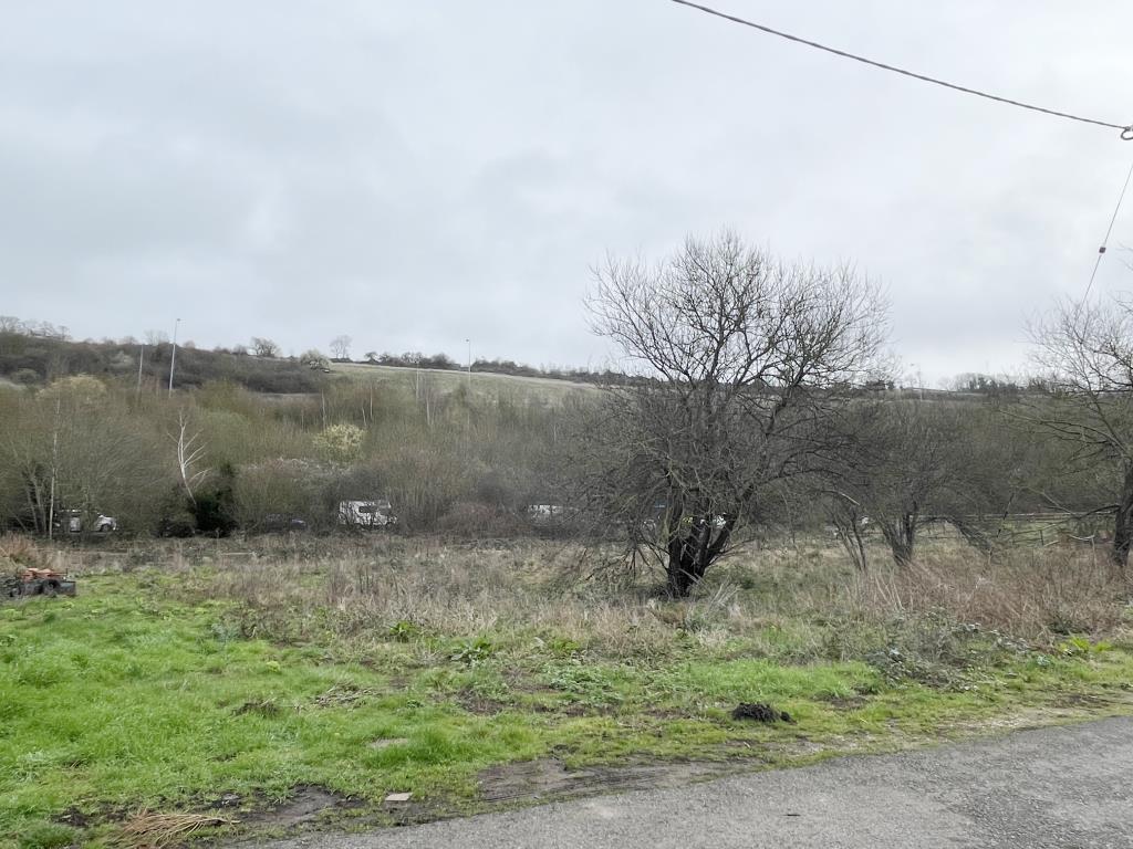 Lot: 98 - LAND EXTENDING TO TWO-THIRDS OF AN ACRE WITH PLANNING FOR REPLACEMENT STORAGE BUILDING - View across land for redevelopment